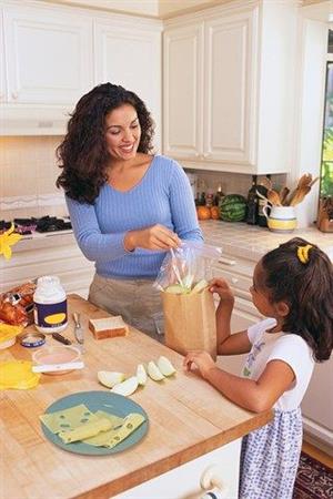 Mom and daughter packing a school lunch